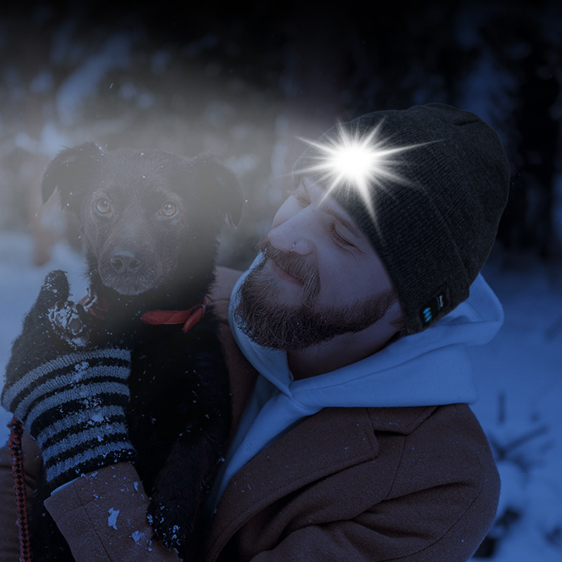 Man wearing the AeroBeanie with its LED light switched on at night